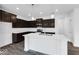 Gourmet kitchen features dark cabinets, granite countertops, island with seating, and modern appliances at 1145 Bevy Blvd, Danville, IN 46122