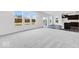 Open-concept living room showcasing gray flooring, large windows, and sliding glass doors at 1145 Bevy Blvd, Danville, IN 46122