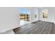 Bright living room with gray flooring, large windows, and sliding doors at 1145 Bevy Blvd, Danville, IN 46122