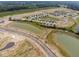 Aerial view of a new construction community with single-Gathering homes and a pond at 1567 Hanover St, Danville, IN 46122