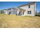 View of a simple backyard and the exterior of the house with patio at 1567 Hanover St, Danville, IN 46122