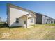 Exterior showcasing a patio and a view of the backyard, with a mix of grass and architectural design at 1567 Hanover St, Danville, IN 46122