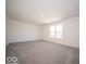 Spacious carpeted bedroom with large window offering plenty of natural light at 1567 Hanover St, Danville, IN 46122