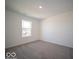 Cozy bedroom with neutral carpet and natural light from the window at 1567 Hanover St, Danville, IN 46122