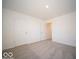 Bright bedroom featuring neutral carpet, white walls, and minimalist design for a calming space at 1567 Hanover St, Danville, IN 46122
