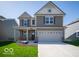 Charming two-story home with neutral siding, well-manicured lawn, and a two car garage at 1567 Hanover St, Danville, IN 46122