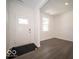 Bright foyer boasting hardwood floors, a modern front door, and a sunlit window at 1567 Hanover St, Danville, IN 46122