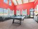 Bright game room featuring a pool table, shuffleboard, large windows, and modern decor at 1567 Hanover St, Danville, IN 46122
