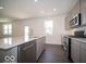 Well-appointed kitchen with stainless steel appliances, quartz countertops, and a convenient breakfast bar at 1567 Hanover St, Danville, IN 46122
