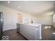 Open kitchen with modern stainless appliances and breakfast bar flows into living area at 1567 Hanover St, Danville, IN 46122
