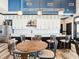 Modern kitchenette with white cabinets, stainless steel appliances, island with seating and stylish lighting at 1567 Hanover St, Danville, IN 46122