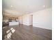Open-concept living room features luxury vinyl plank flooring and connects to kitchen with stainless steel appliances at 1567 Hanover St, Danville, IN 46122