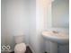 Cozy powder room features a modern toilet and pedestal sink with a large mirror at 1567 Hanover St, Danville, IN 46122
