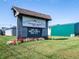 Beasley's Orchard sign with hours posted, flowers, and green grass at 1567 Hanover St, Danville, IN 46122