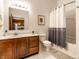 Bathroom featuring a vanity with storage, framed mirror, and shower with curtain at 233 E Saint Joseph St # 3E, Indianapolis, IN 46202