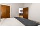 Well-lit bedroom with hardwood door and a glimpse of a modern kitchen at 233 E Saint Joseph St # 3E, Indianapolis, IN 46202