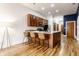 Modern kitchen features a breakfast bar with three seats, wood cabinets, stainless steel appliances and hardwood floors at 233 E Saint Joseph St # 3E, Indianapolis, IN 46202
