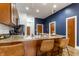 Kitchen island featuring stainless steel sink, bar seating, pendant lighting and stainless steel appliances at 233 E Saint Joseph St # 3E, Indianapolis, IN 46202