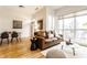 Bright living room with a modern leather sofa, a white coffee table, and hardwood floors at 233 E Saint Joseph St # 3E, Indianapolis, IN 46202