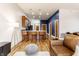 Open concept living room with a kitchen bar, leather sofa, hardwood floors, and modern decor at 233 E Saint Joseph St # 3E, Indianapolis, IN 46202