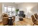 Cozy living room with a large window, modern furniture, hardwood floors, and neutral decor at 233 E Saint Joseph St # 3E, Indianapolis, IN 46202