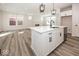 Kitchen island featuring white cabinets, a sink, and views of the living area at 3917 Holly Brook Dr, Westfield, IN 46062