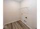 Bright laundry room featuring wood-look flooring and convenient hookups at 3917 Holly Brook Dr, Westfield, IN 46062