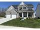 Charming two-story home with a well-manicured lawn, two-car garage, and stone and brick facade at 4958 Reavie Ct, Noblesville, IN 46062