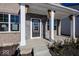 Modern front entrance with a covered porch and black front door at 4958 Reavie Ct, Noblesville, IN 46062