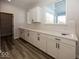 Bright laundry room with white cabinets and vinyl flooring at 4958 Reavie Ct, Noblesville, IN 46062