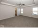 Large main bedroom with plush carpeting and ensuite bathroom at 4958 Reavie Ct, Noblesville, IN 46062