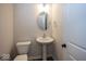 Clean powder room with pedestal sink and oval mirror at 4958 Reavie Ct, Noblesville, IN 46062