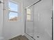 Bathroom featuring a glass-enclosed shower and a bright window at 5127 Rolling Meadow Blvd, Indianapolis, IN 46237