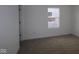 Simple bedroom with carpeted floor and a window at 5127 Rolling Meadow Blvd, Indianapolis, IN 46237