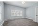 Bright bedroom with neutral walls, new carpet, and multiple windows at 620 S 18Th St, Elwood, IN 46036