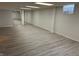 Unfinished basement features updated flooring, glass block window and mirrored closet for storage at 6822 Bruton Dr, Indianapolis, IN 46256