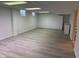 Spacious basement with new flooring, glass block windows, storage cabinets, and bright lighting at 6822 Bruton Dr, Indianapolis, IN 46256
