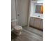 Half bath features modern vanity with ample storage and updated gray flooring at 6822 Bruton Dr, Indianapolis, IN 46256
