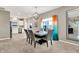 Elegant dining room with stylish table, seating for six, and a view into the modern kitchen at 7062 English Oak Dr, McCordsville, IN 46055