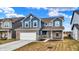 Charming two-story home with blue siding, brick accents, attached two-car garage, and well-maintained lawn at 7062 English Oak Dr, McCordsville, IN 46055