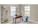 Bright office space featuring two windows, a modern desk, chairs, and stylish shelving at 7062 English Oak Dr, McCordsville, IN 46055