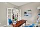 Bright office space featuring glass French doors, a modern desk, chairs, stylish shelving, and modern decor at 7062 English Oak Dr, McCordsville, IN 46055