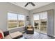 Bright sunroom featuring windows with lake views, patio access, and comfortable wicker seating at 7062 English Oak Dr, McCordsville, IN 46055