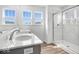 Bathroom featuring double sinks, a glass-enclosed shower, and modern fixtures, creating a spa-like experience at 16043 Meadow Frost Ct, Fishers, IN 46037