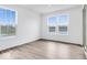 Sunlit bedroom with hardwood floors and picturesque views from large windows at 16043 Meadow Frost Ct, Fishers, IN 46037