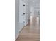 Bright hallway featuring hardwood floors, white walls, and a clear view of the layout at 16043 Meadow Frost Ct, Fishers, IN 46037