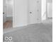 Hallway with carpet and neutral walls, leading to a bathroom and rooms with carpet, providing a quiet interior at 16043 Meadow Frost Ct, Fishers, IN 46037