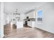 Bright, open floor plan features hardwood floors, white kitchen, and stainless steel appliances at 16043 Meadow Frost Ct, Fishers, IN 46037