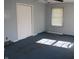 Bedroom with blue carpet, gray walls, a ceiling fan, and a large closet at 406 S Fenton Ave, Indianapolis, IN 46219