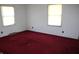 Bedroom featuring red carpet, white walls, and window letting in natural light at 406 S Fenton Ave, Indianapolis, IN 46219